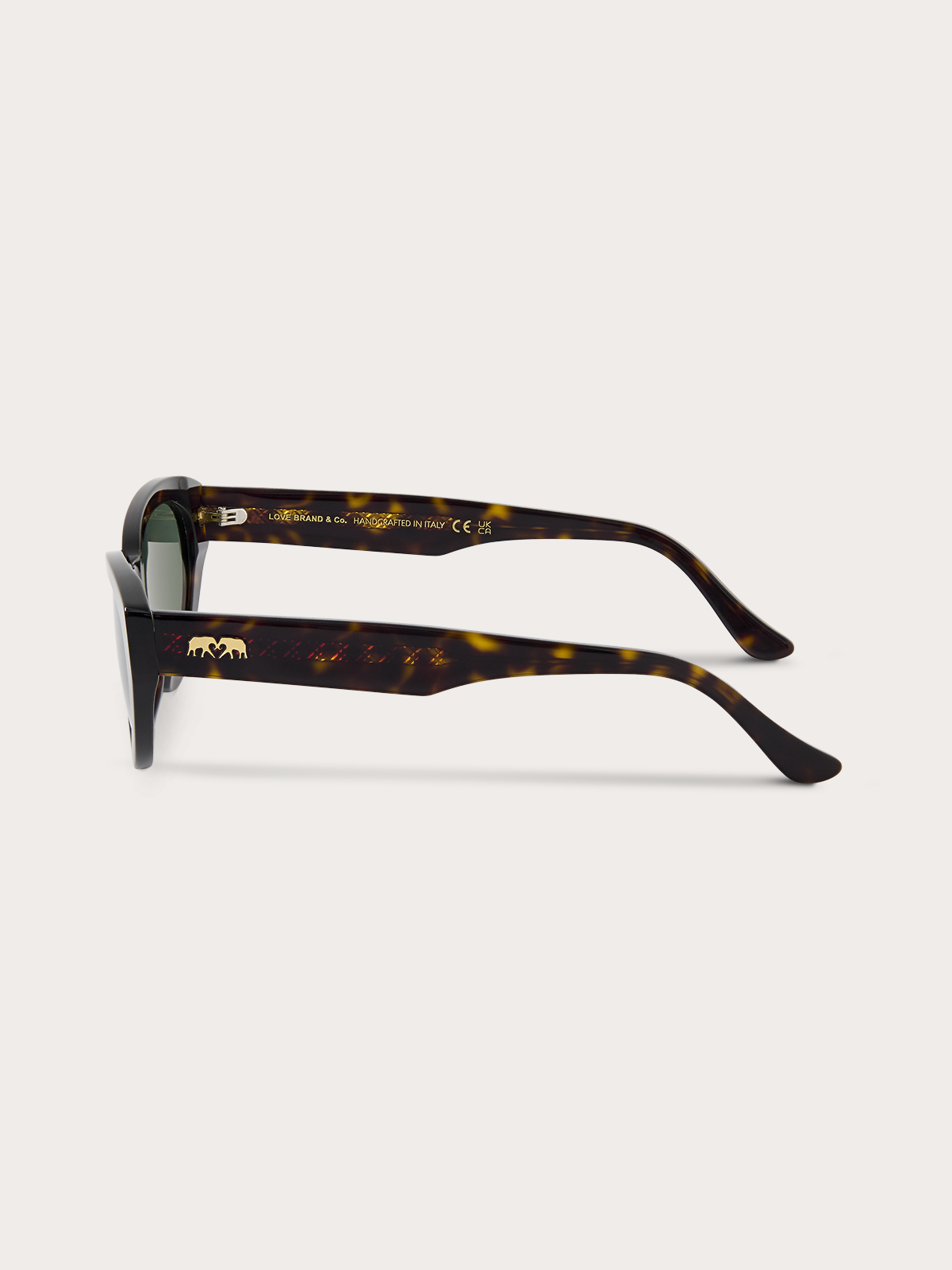 Side view of tortoiseshell sunglasses with gold accents