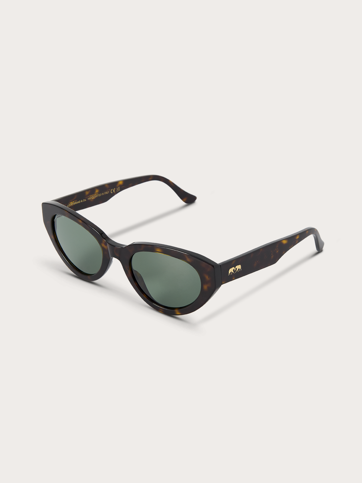 Sunglasses with tortoiseshell frame and green lenses on a white background