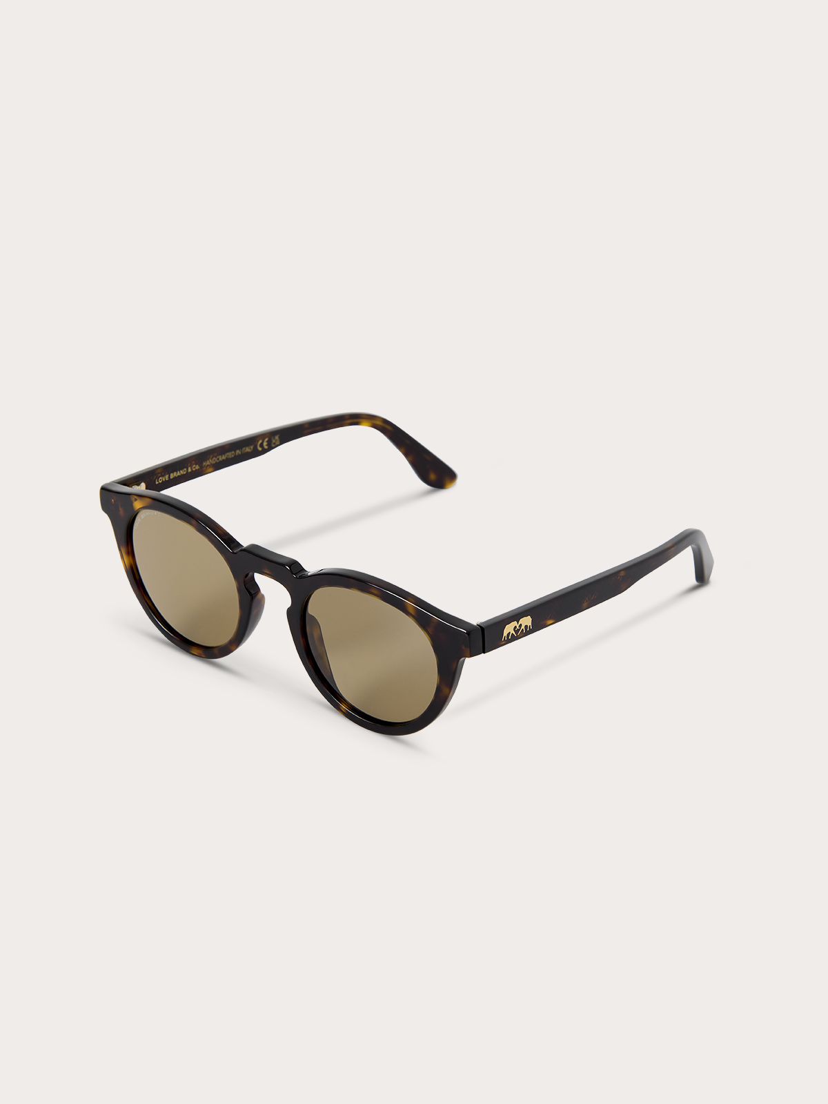 Top down view of sunglasses with tortoiseshell frame and brown lenses on a white background
