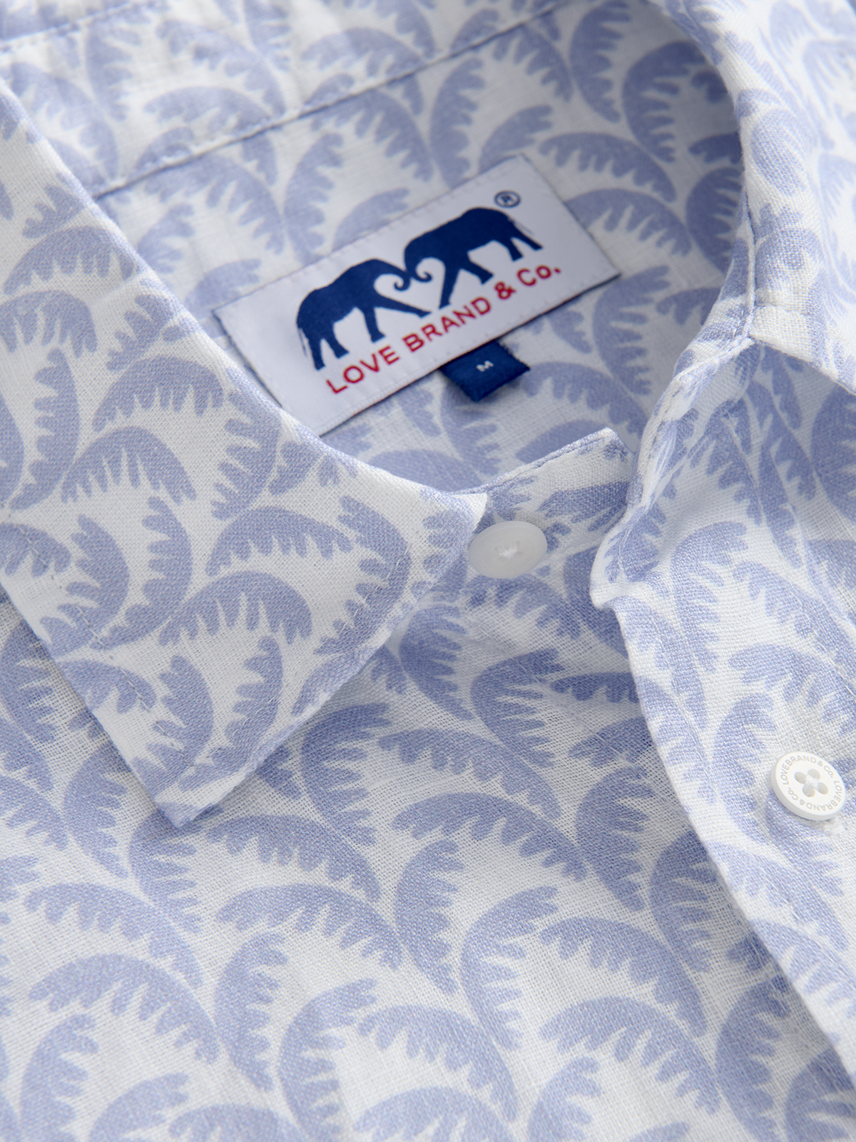 Close-up of a blue patterned shirt with a visible brand label.