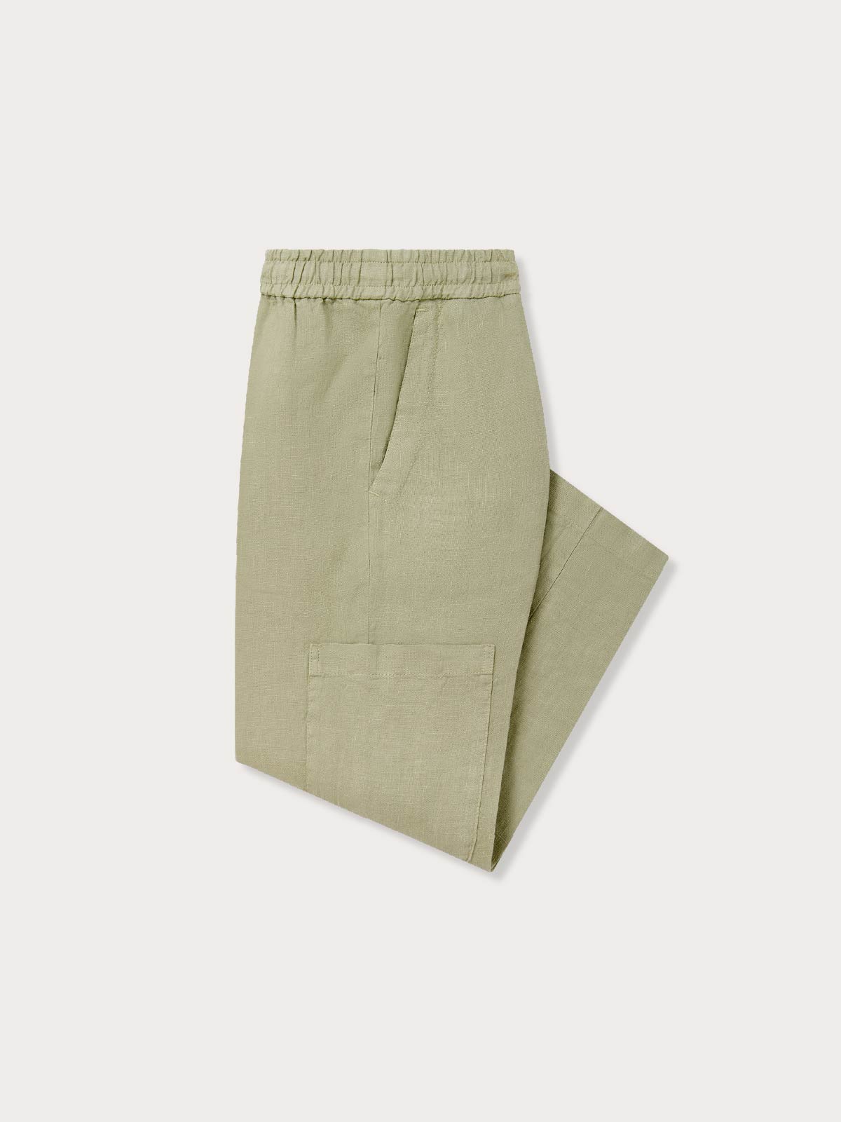 Folded side view of kids green linen trousers.