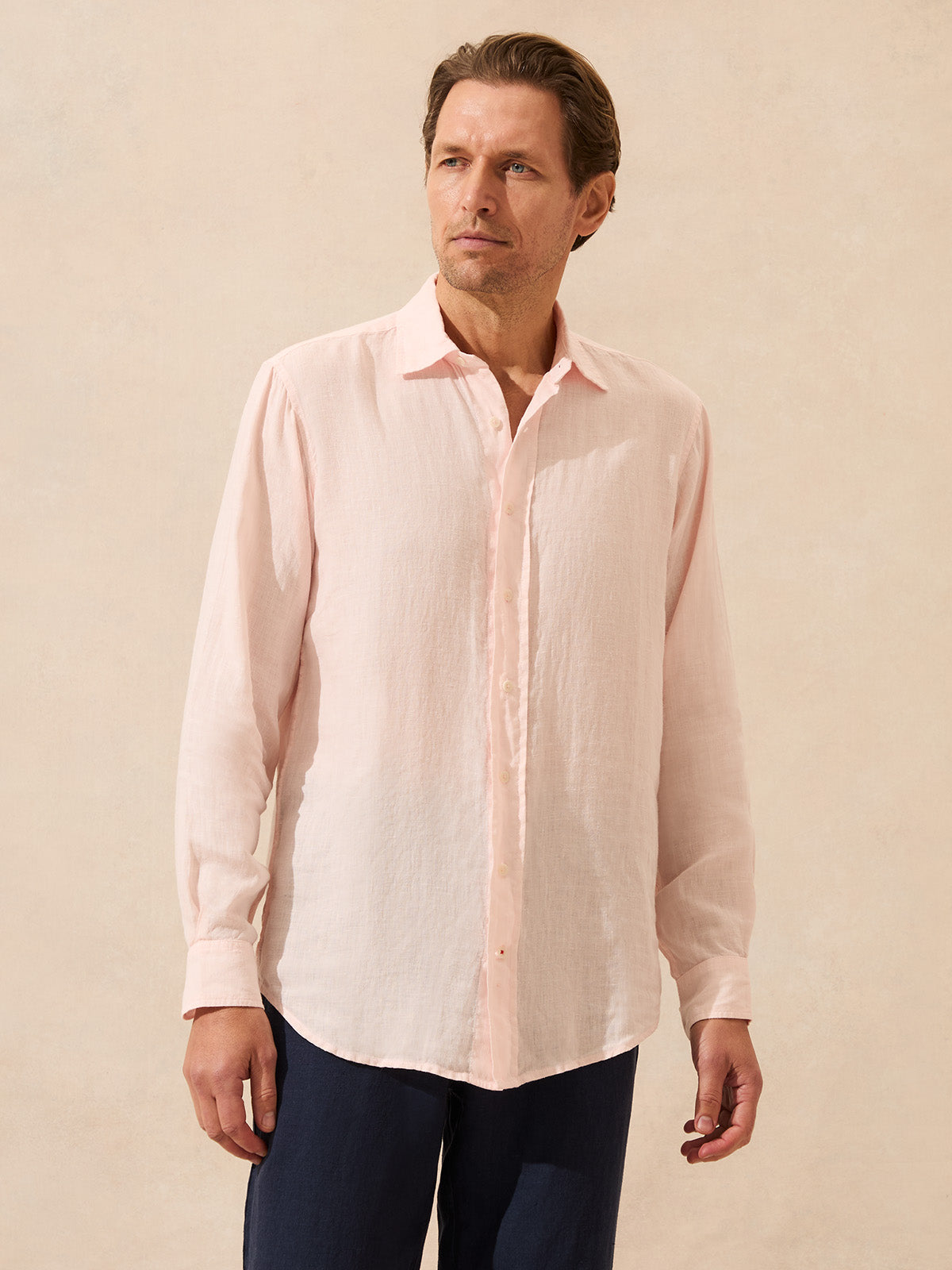 Man wearing a light pink linen shirt with long sleeves
