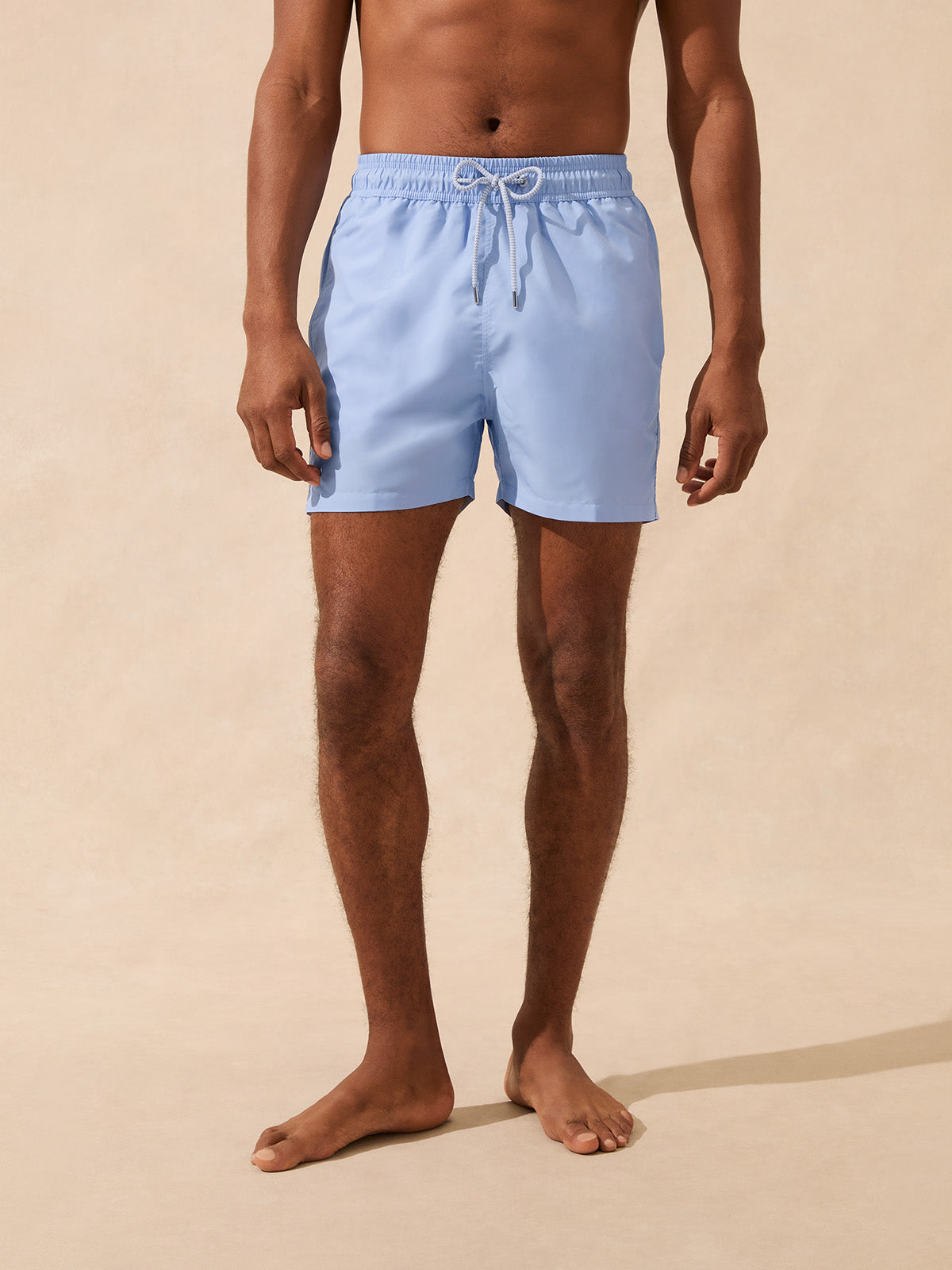 Man wearing light blue swim shorts