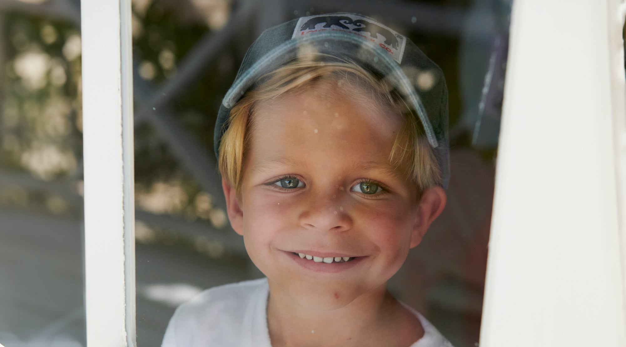 child wears blue baseball cap
