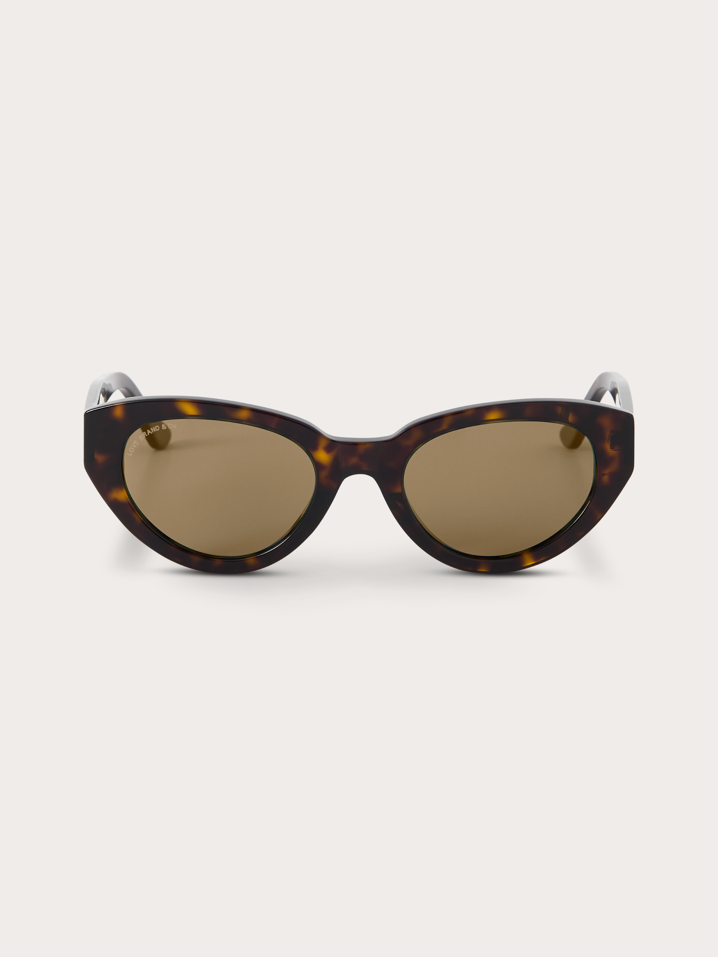 Sunglasses with tortoiseshell frame and brown lenses on a white background