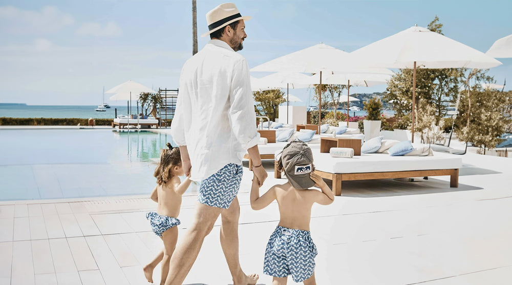 Oliver Tomalin and his children wearing sustainable swimwear