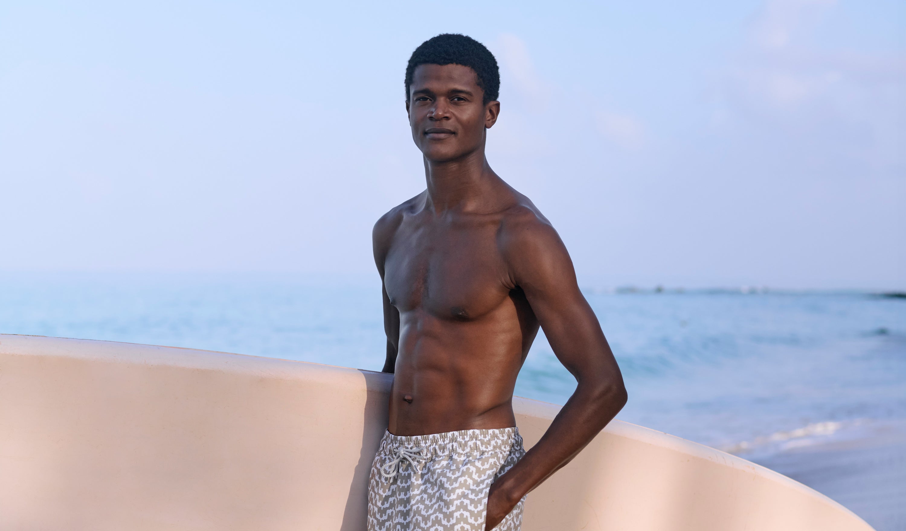 man wears green swim trunks in the sea