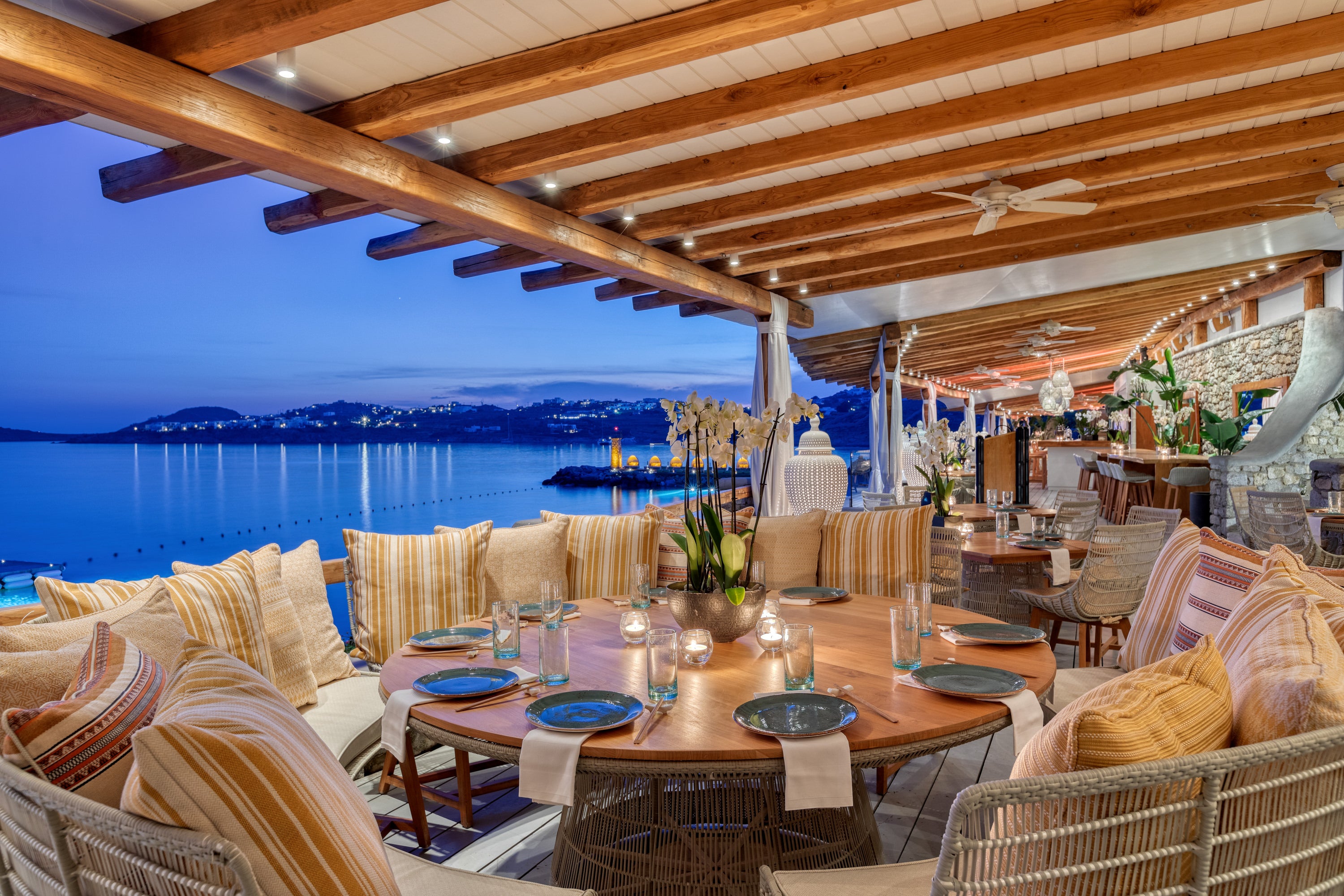 Buddha Bar and restaurant at Santa Marina resort showing outdoor dining tables at sunset.
