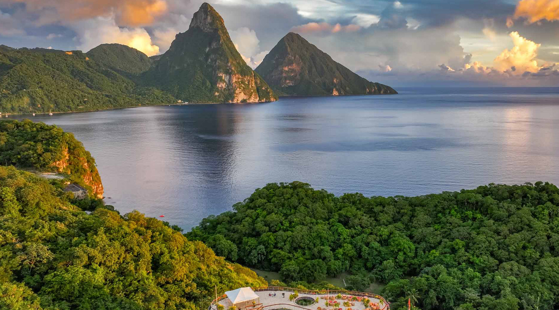 Lush green Piton mountains and a body of water with a scenic view.