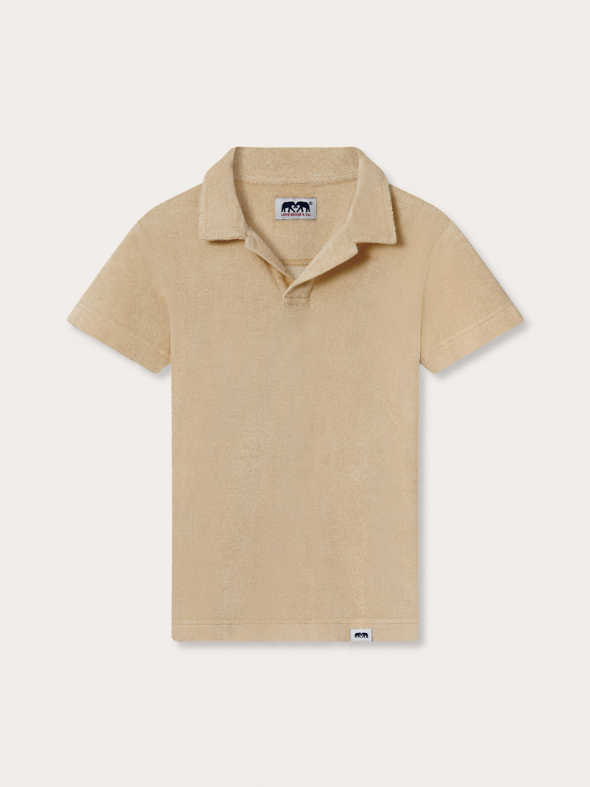 Front view of Kids Coconut Powell Terry Polo. Beige polo shirt for kids made of terry towelling.