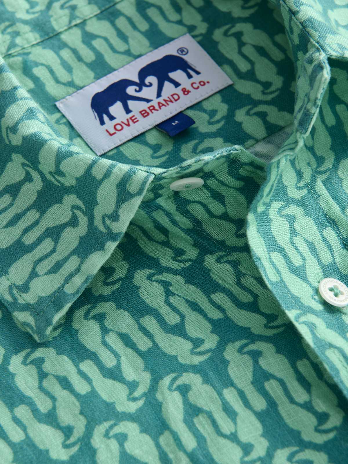 Green patterned shirt with a visible brand label