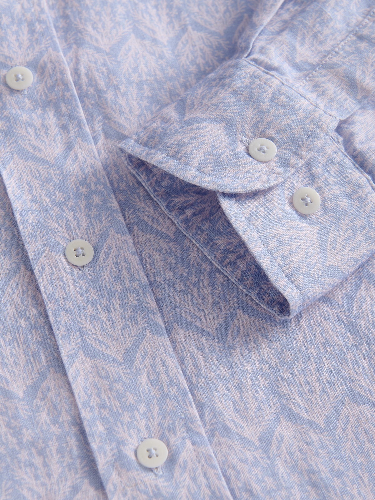 Close-up of a light blue patterned shirt with buttons