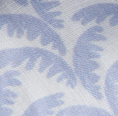 Textured fabric pattern with blue and white palm leaves on a light background