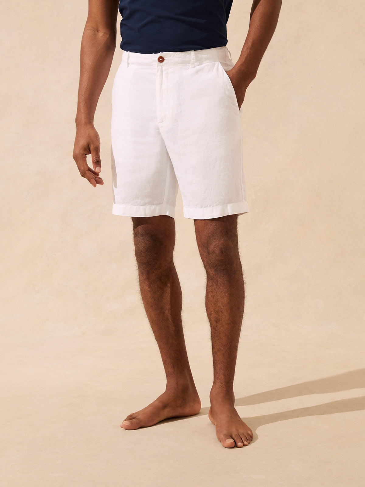 Man wearing a pair of white linen shorts